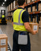 Warehouse worker wearing gray Getac tablet waist belt case while carrying boxes during order fulfillment