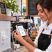 Café worker connecting a Stripe Reader S700 and S710 to an Agoz white wall charger and USB-C cable