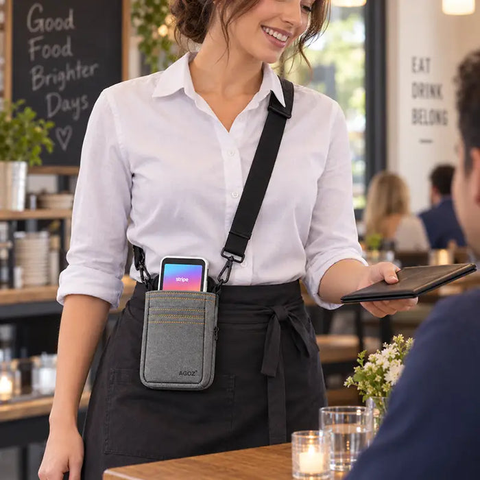 Restaurant server wearing a gray Agoz crossbody holster with Stripe Reader during tableside service