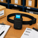 AgozTech Almex Mobile Terminal Waist Belt Case for inventory teams shown on a warehouse packing table with barcode labels, pick list, SKU carton, and black waist belt.