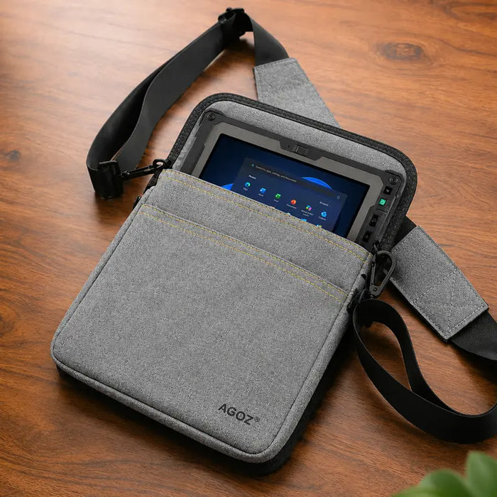 Gray Getac tablet carrying case with shoulder sling on wood tabletop with rugged tablet secured inside