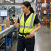 Worker holding a Honeywell mobile computer with an AgozTech black tool pouch worn on a waist belt in a warehouse packing area.