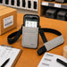 Gray Newland shoulder sling holster on a warehouse workstation with barcode labels, pick list, and packing supplies.