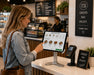 A customer at self checkout with Rhino POS stand