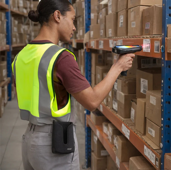 Warehouse worker scanning shelf barcode with Zebra TC58 scanner and AgozTech holster case