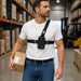 a man with Datalogic scanner harness carrying a package in a warehouse