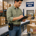 A shipping area employee with a  elo scanner grip holster is taking inventory