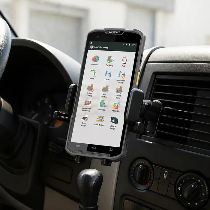 Newland mobile computer secured in an air vent vehicle cradle holder inside a commercial vehicle dashboard.