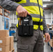 Close-up of an AgozTech black tool pouch holding a Honeywell mobile computer and tools on a warehouse worker’s waist belt.