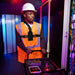 Technician wearing AgozTech chest harness holster with Uniden radio scanner