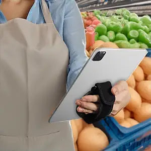 Worker holding Panasonic tablet with Tablet Hand Grip for Rugged Panasonic Tablets in grocery store setting